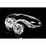 A Two Stone Diamond Crossover Ring, Early 20th Century, in platinum mount, set with brilliant cut