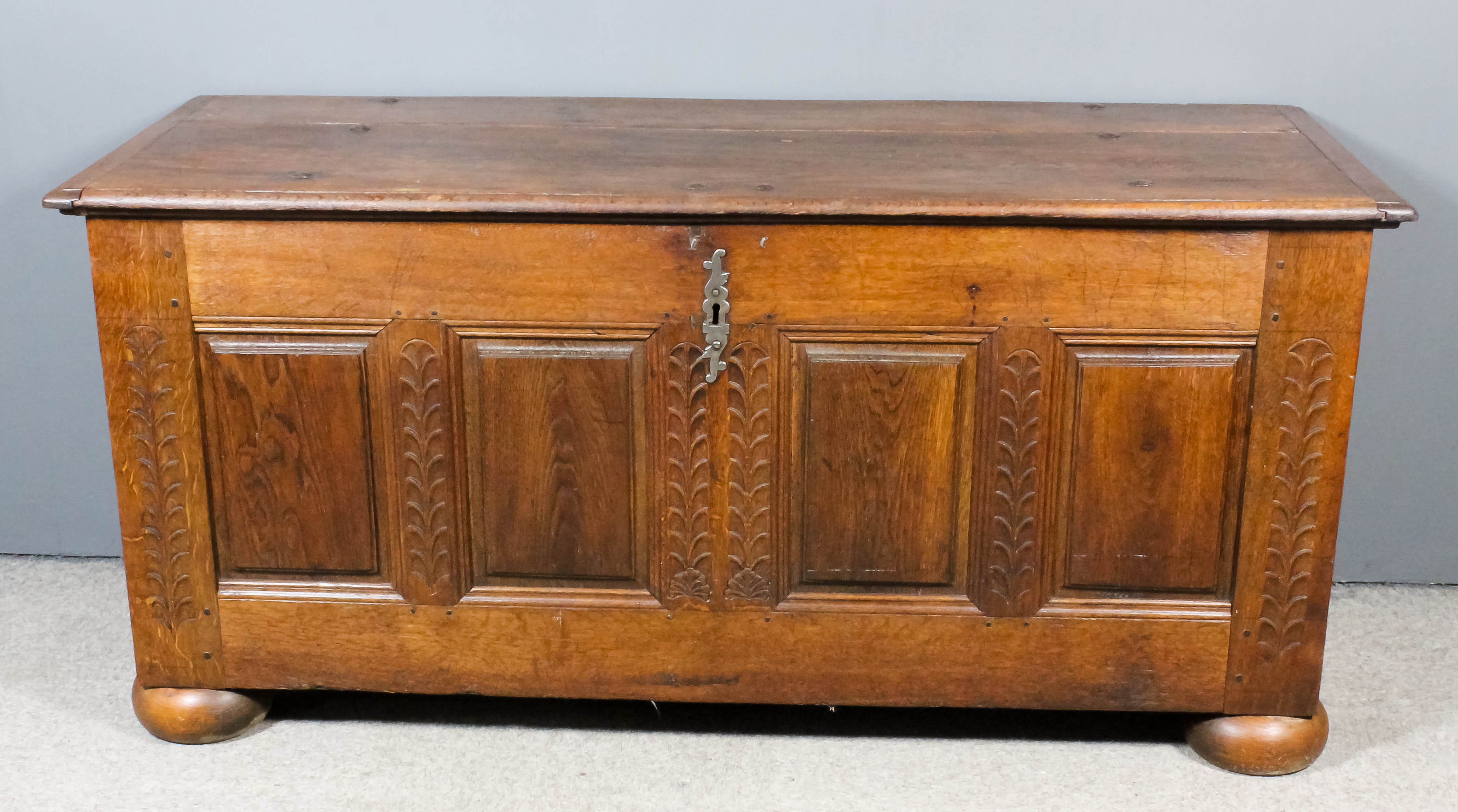 A French Provincial Oak Coffer, 18th Century with two plank cleated top, the front with four