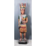 A Standing Carved and Painted Figure of a Native North American, Modern, holding a quantity of