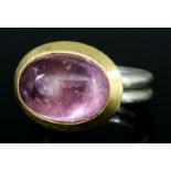 A Pink Tourmaline Ring, Modern, by Mark Nuell, in silver mount, set with an oval cabochon