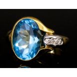 A Blue Topaz and Diamond Ring, Modern, in 18ct gold mount, set with an oval faceted topaz,