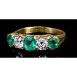 An Emerald and Diamond Five Stone Ring, 20th Century, in 18ct gold mount, set with three emeralds,