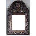 A Carved Walnut Rectangular Wall Mirror, 19th Century, of 17th Century Italian design, the shaped