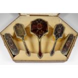 A George V Silver Gilt and Tortoise Shell Backed Five Piece Dressing Table Set, by William