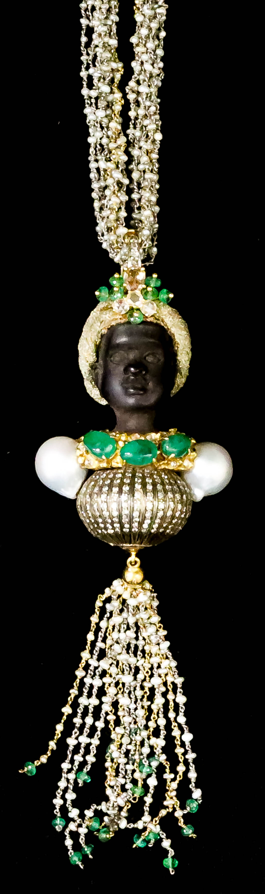 A Carved Wood, Gold, Emerald, Diamond and Pearl "Blackamoor" Pendant, set with emeralds, approximate