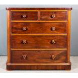 A Victorian Mahogany Chest, with rounded front corners and square edge to top, fitted two short