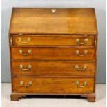 An 18th Century Oak Bureau, the slope enclosing shaped interior, fitted central cupboard, six