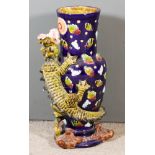 A Majolica Vase/Stick Stand, moulded in relief and decorated in colours with dragon cloud motifs, on