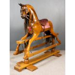 A Large Modern Walnut Rocking Horse, by Stevenson Brothers, 1997, No. 2561, on stand, 58ins high x