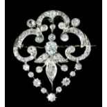 A Diamond Brooch, Early 20th Century, in platinum and gold mount, of open scroll and leaf pattern,
