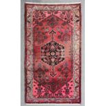 A Tabriz Rug woven in colours with bold central hexagonal medallion, the field filled with