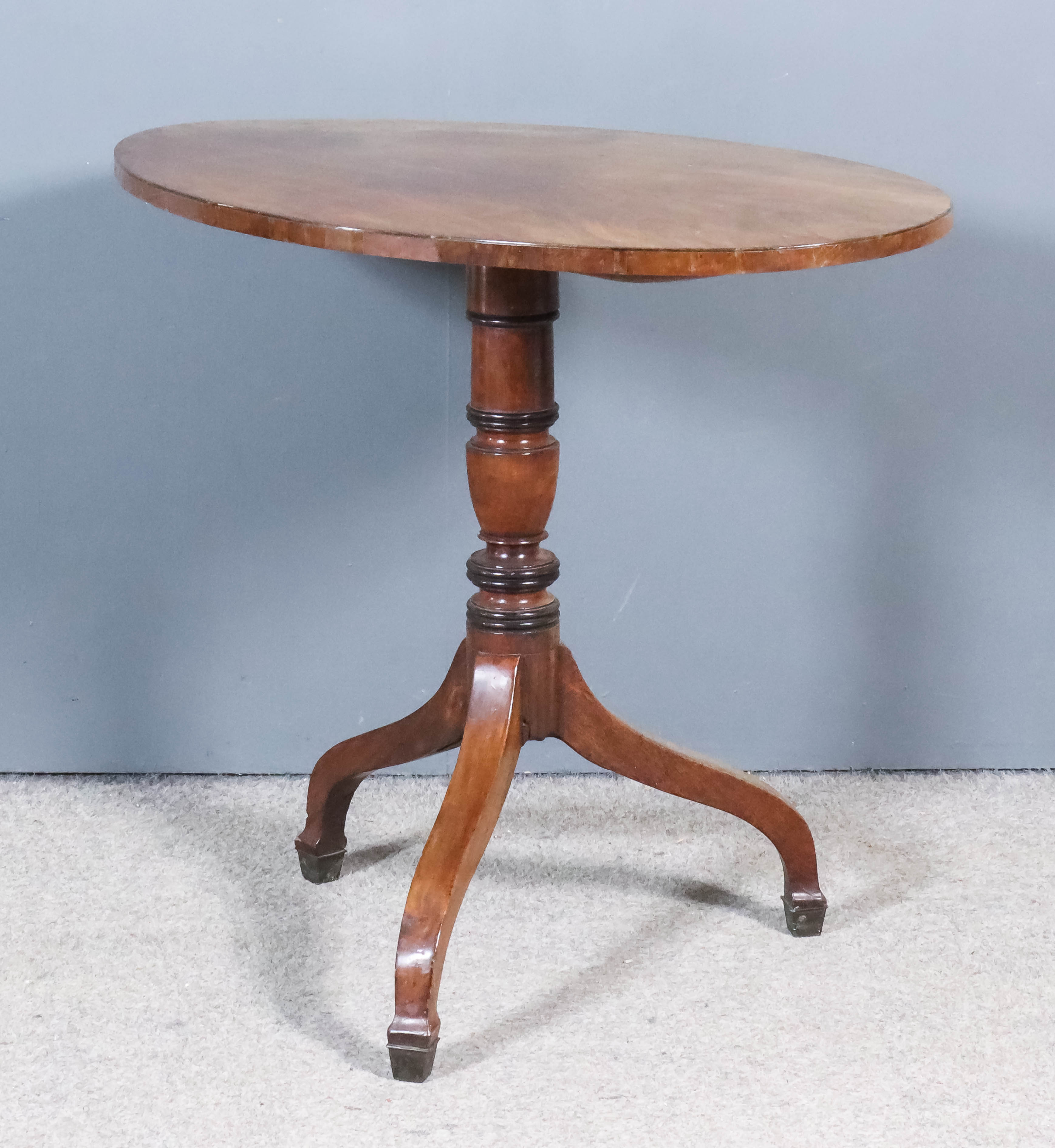 A 19th Century Mahogany Oval Tripod Table, on turned central column and splayed legs with block