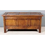 A Panelled Oak Coffer of "17th Century" Design, with moulded and chamfered rails, with three-panel