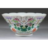A Chinese Famille Rose Porcelain Bowl, Daoguang, enamelled in colours with water lilies, symbols and