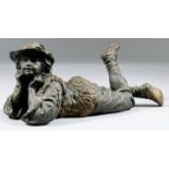 19th Century Continental School - Bronze figure of a Tyrolean boy lying down, his head supported
