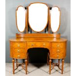 An Edwardian Satinwood Kidney Shaped Kneehole Dressing Table, inlaid with stringings, with shield