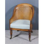 A George IV Mahogany Framed Tub Shaped Bergere Armchair, with arched cane panelled back and cane