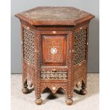 An Indian Hardwood Hexagonal Occasional Table, the top carved with a star motif and inlaid in