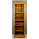 A Modern Panelled Oak Tall Bookcase, with moulded cornice, fitted five adjustable shelves flanked by