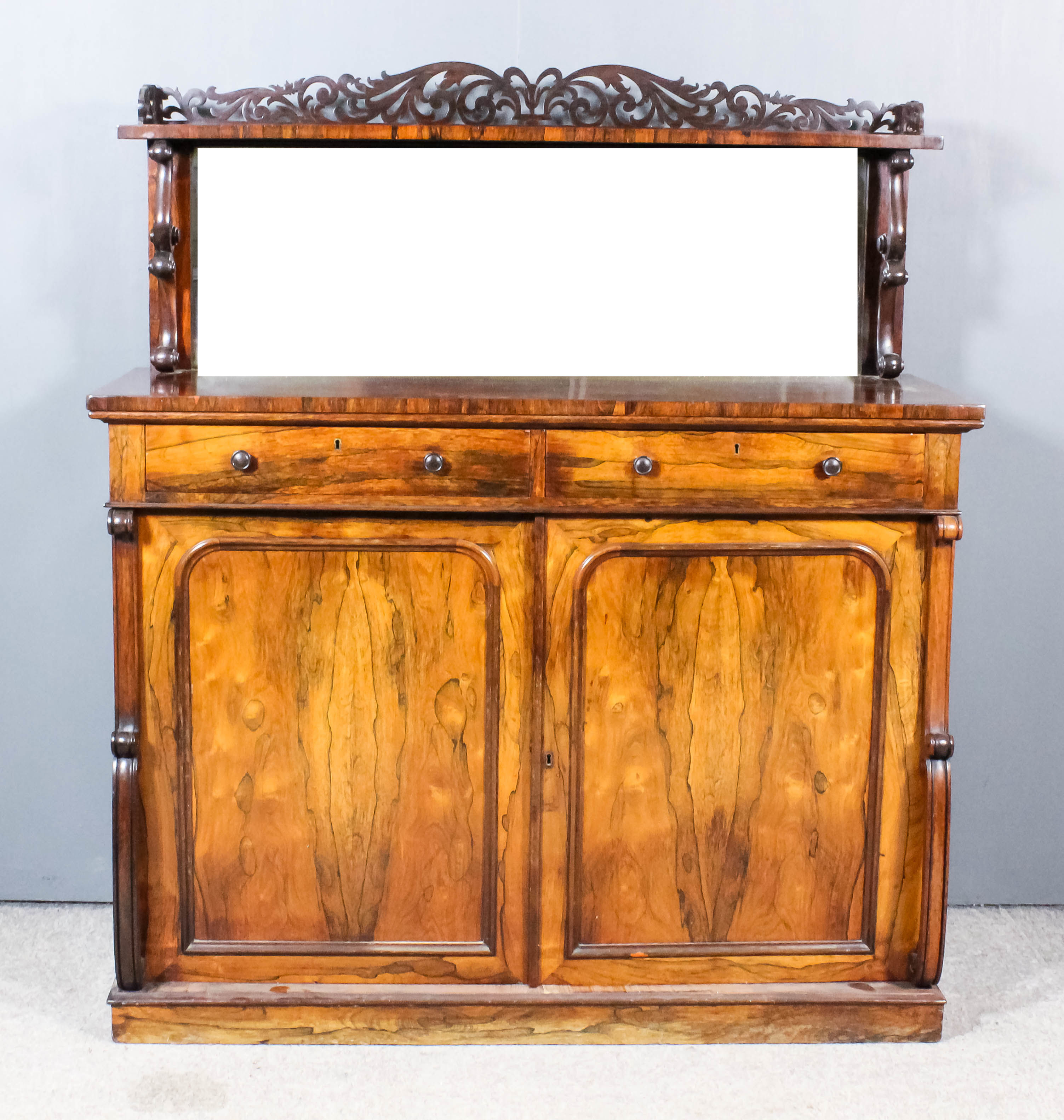 A William IV Rosewood Chiffonier, the upper part with tray top shelf with fretted and carved back,