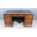 A Late Victorian Panelled Mahogany Rectangular Kneehole Desk, with tooled black leather inset to top