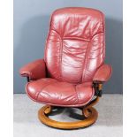 A Norwegian Ekornes Stressless Easychair, upholstered in maroon leather, on stained wood base