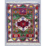 A Kazak Rug woven in colours with central lozenge shaped medallion and two rectangular medallions