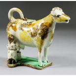 A Yorkshire Pearlware Pottery Cow Creamer and Cover, with Milkmaid, Early 19th Century, with