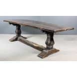 An Old Oak Refectory Table, with heavy two-plank cleated top on square baluster end supports and
