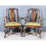 A Pair of Walnut Armchairs of "George II" Design, with shaped crest rails and solid vase pattern