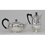 An Edward VII Silver Circular Tea Pot and a Late Victorian Cylindrical Hot Water Pot, the tea pot by
