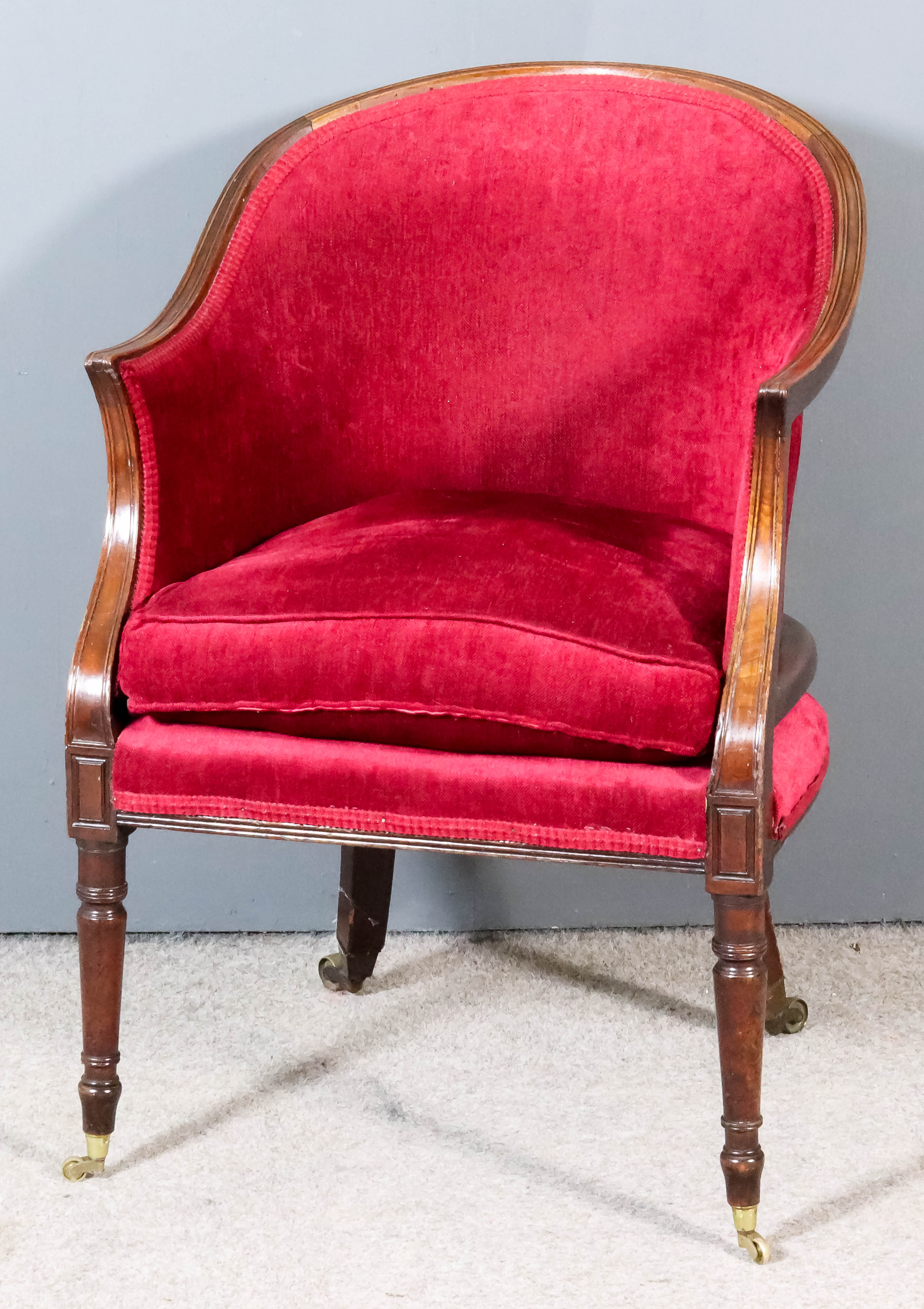 A Mahogany Tub Shaped Easy Chair of "Georgian" Design, with moulded showwood frame, upholstered in