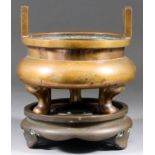 A Chinese Two-Handled Bronze Censer and Stand, the censer of flattened form standing on three