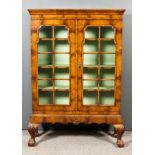 A 1930's Walnut Display Cabinet of "18th Century" design, with moulded cornice, fitted three shelves