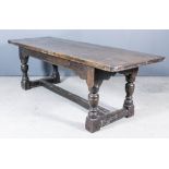 An Old Oak Refectory Table of 17th Century Design, with three-plank cleated top on heavy turned