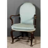 A Walnut Open Armchair of "Early 18th Century" Design, the shaped back and seat upholstered in