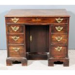 A George III Lady's Mahogany Kneehole Dressing Table, with moulded edge to top, fitted one frieze