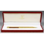 A Cartier Stylo Bille Must Gold Coloured Ballpoint Pen, 381816, 1986, with enamelled clip,