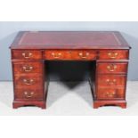 A Modern Mahogany Kneehole Desk, with red leather inset to top and moulded edge, fitted three frieze