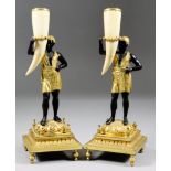 A pair of Continental gilt brass and bronze finish candlesticks, 19th Century, modelled as