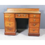 An Edwardian Mahogany Kneehole Dressing Table, inlaid with chequered stringings, fitted nine