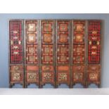 A Chinese Six Fold Lacquered Wooden Screen, 20th Century, with blind fret and raised panels,