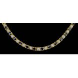 A Sapphire and Diamond Line Necklace, Modern, in gold coloured metal mount, set with forty-three