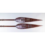 Two African Hardwood Paddles, 20th Century, the blades with stylised simple chip carving and