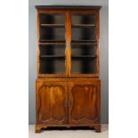 An Early George III Mahogany Bookcase, the upper part with moulded and dentil cornice, fitted