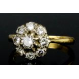 A Diamond Flowerhead Pattern Ring, 20th Century, in 18ct gold mount, set with nine round brilliant