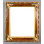 A Grained Wood and Parcel Gilt Rectangular Wall Mirror, the moulded border with shell, scroll and