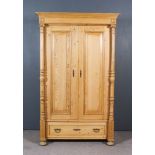 A 19th Century Eastern European Stripped Pine Dwarf Armoire, with moulded cornice, now fitted with a