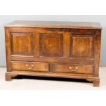 An 18th Century Panelled Oak Mule Chest, the top and front inlaid with crossbandings, with raised