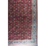 A 20th Century Tabriz Carpet, woven in ivory, wine and turquoise, the field filled with trailing